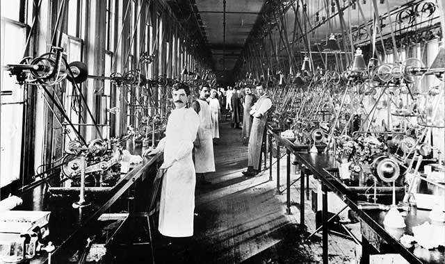 Historic watch craftsmen inside a factory