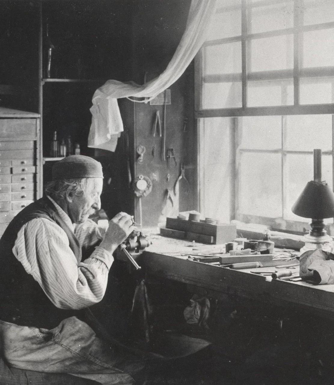 Historic watchmaker working at a bench